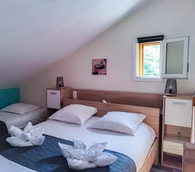 Un ou plusieurs lits dans un hébergement de l'établissement Village Drôles d'Oiseaux