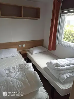 Un ou plusieurs lits dans un hébergement de l'établissement MOBILHOME 3 CHBRES 2 SDE 2 WC LV LL TV CLIM TOUT CONFORT