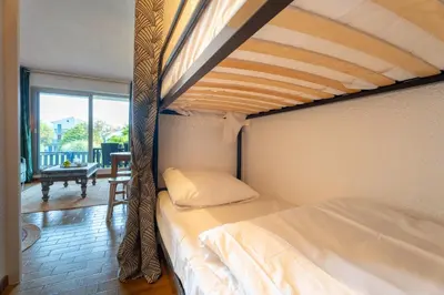 Un ou plusieurs lits dans un hébergement de l'établissement Studio plage de Capbreton avec terrasse
