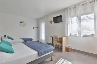 Un ou plusieurs lits dans un hébergement de l'établissement Hotel du Cap
