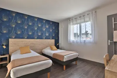 Un ou plusieurs lits dans un hébergement de l'établissement Hotel du Cap