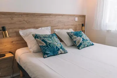 Un ou plusieurs lits dans un hébergement de l'établissement Hotel du Cap