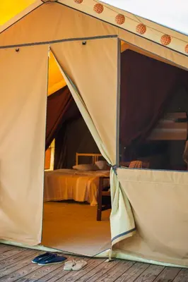 Un ou plusieurs lits dans un hébergement de l'établissement Tente Lodge La Téouleyre