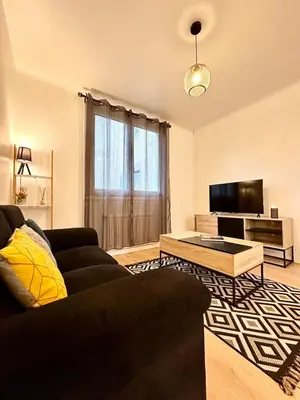Télévision ou salle de divertissement dans l'établissement L'Évasion - Centre-Ville & Garage Privé