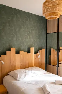 Un ou plusieurs lits dans un hébergement de l'établissement Maison chaleureuse 3* à deux pas de la plage