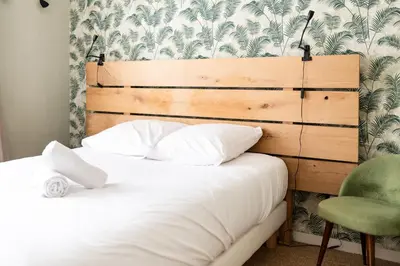 Un ou plusieurs lits dans un hébergement de l'établissement Maison chaleureuse 3* à deux pas de la plage