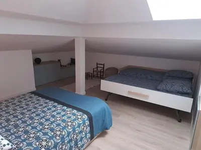 Un ou plusieurs lits dans un hébergement de l'établissement Spacieux appartement neuf au cœur de Bisca plage