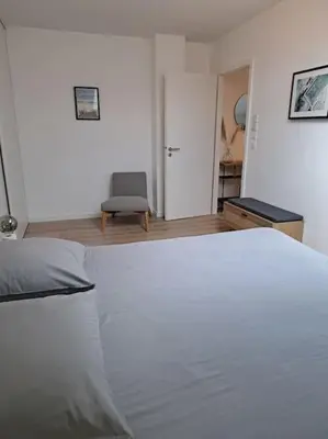 Un ou plusieurs lits dans un hébergement de l'établissement Spacieux appartement neuf au cœur de Bisca plage