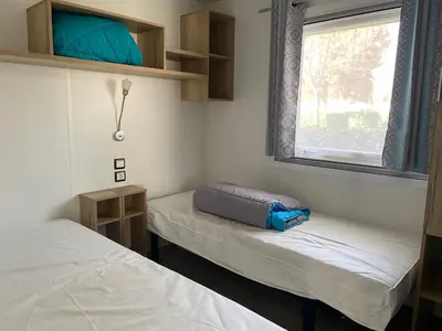 Un ou plusieurs lits dans un hébergement de l'établissement MOBIL HOME 2 CHAMBRES CLIMATISE