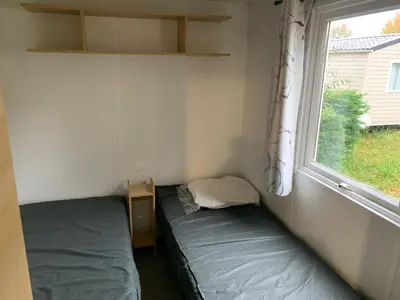 Un ou plusieurs lits dans un hébergement de l'établissement Mobil-Home -10 minutes Océan