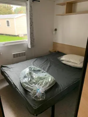 Un ou plusieurs lits dans un hébergement de l'établissement Mobil-Home -10 minutes Océan