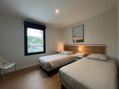 Un ou plusieurs lits dans un hébergement de l'établissement Villas-des-oyats - Arena - 8 personnes climatisée piscine chauffée