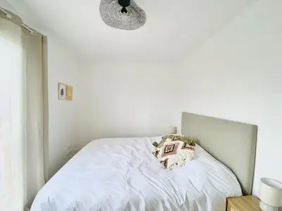 Un ou plusieurs lits dans un hébergement de l'établissement Maison de vacances à 5 minutes de l'océan et des commerces