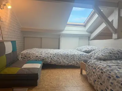 Un ou plusieurs lits dans un hébergement de l'établissement Jolie petite maison climatisée parking privé