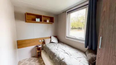 Un ou plusieurs lits dans un hébergement de l'établissement Camping Officiel Siblu La Pointe