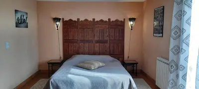 Un ou plusieurs lits dans un hébergement de l'établissement Les chambres du trouilh