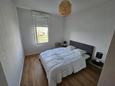 Un ou plusieurs lits dans un hébergement de l'établissement Appartement duplex Mimizan plage
