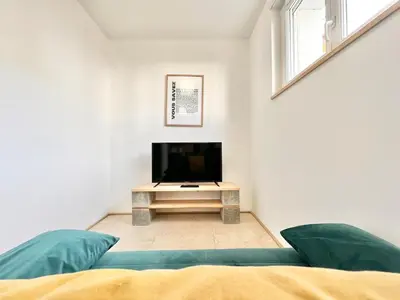 Télévision ou salle de divertissement dans l'établissement L'Esplanade - Confort & Lumineux