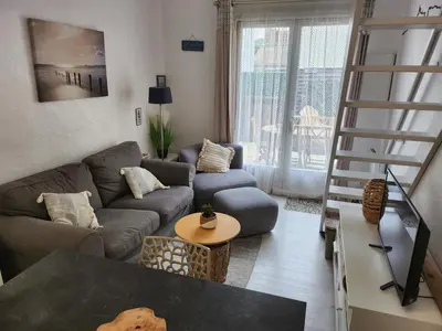 Coin salon dans l'établissement Capbreton - Villa Patio - Climatisé - Port - Surf