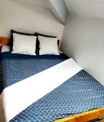 Un ou plusieurs lits dans un hébergement de l'établissement Studio Duplex Moliets