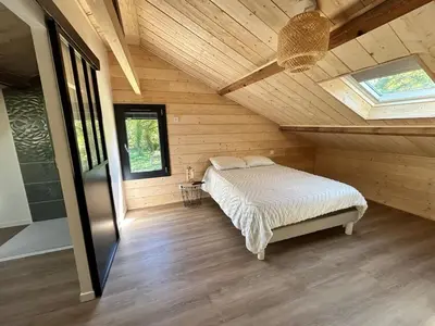 Un ou plusieurs lits dans un hébergement de l'établissement Maison dans les bois