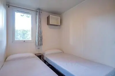 Un ou plusieurs lits dans un hébergement de l'établissement Camping Le Soleil des Landes