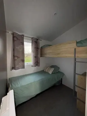 Un ou plusieurs lits dans un hébergement de l'établissement Chalet en bois