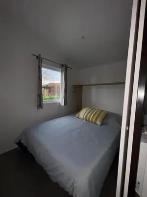 Un ou plusieurs lits dans un hébergement de l'établissement Chalet en bois