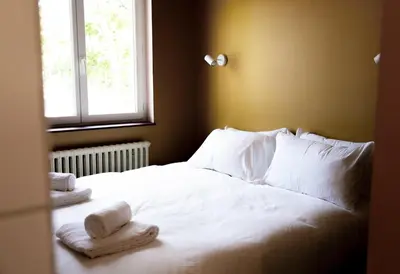 Un ou plusieurs lits dans un hébergement de l'établissement Hotel Bleu Soleil