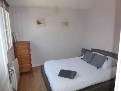 Un ou plusieurs lits dans un hébergement de l'établissement Maison style chalet au calme