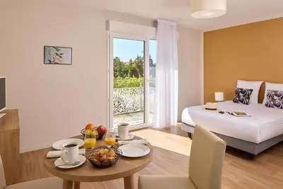 Un ou plusieurs lits dans un hébergement de l'établissement Quality Aparthotel Saint-Paul-lès-Dax