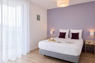 Un ou plusieurs lits dans un hébergement de l'établissement Quality Aparthotel Mont-de-Marsan