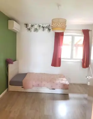 Un ou plusieurs lits dans un hébergement de l'établissement Maison familiale à 6 minutes de l'océan