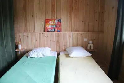 Un ou plusieurs lits dans un hébergement de l'établissement Maison bois Lesbats