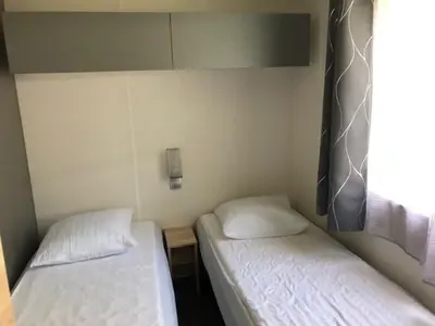 Un ou plusieurs lits dans un hébergement de l'établissement Mobilhome camping Rivage des Landes