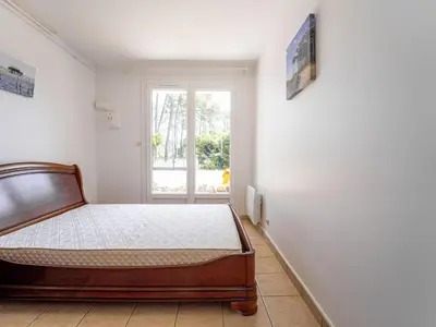 Un ou plusieurs lits dans un hébergement de l'établissement Appartement calme entre courant et océan, 4 personnes, terrasse - FR-1-50-189
