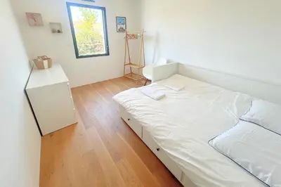 Un ou plusieurs lits dans un hébergement de l'établissement Maison Calme Biscarosse avec Piscine - 10 min Plage