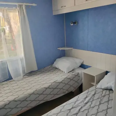 Un ou plusieurs lits dans un hébergement de l'établissement Mobil-home Camping MIMIZAN