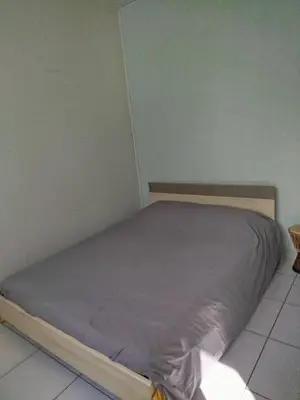 Un ou plusieurs lits dans un hébergement de l'établissement Maison de vacances à Lesperon