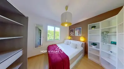 Un ou plusieurs lits dans un hébergement de l'établissement Host Villas LOUMÉA Saubion