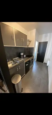Cuisine ou kitchenette dans l'établissement Le cosy de Tom
