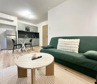 Coin salon dans l'établissement Le Green & Cosy - Neuf - Tout équipé