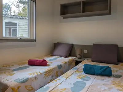 Un ou plusieurs lits dans un hébergement de l'établissement Grand Mobil-home 262