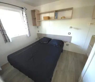 Un ou plusieurs lits dans un hébergement de l'établissement Mobilhome 5 PLACES