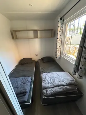 Un ou plusieurs lits dans un hébergement de l'établissement Camping les Olyats