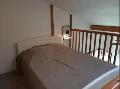 Un ou plusieurs lits dans un hébergement de l'établissement Maison 6 personnes avec jardin derrière la dune