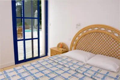 Un ou plusieurs lits dans un hébergement de l'établissement Madame Vacances Villas Club Royal Aquitaine