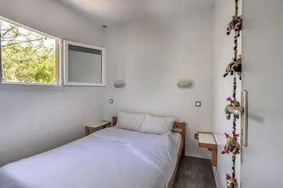 Un ou plusieurs lits dans un hébergement de l'établissement Village Vacances La Forêt des Landes