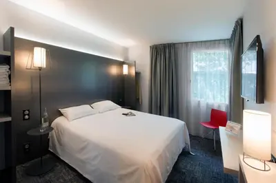 Un ou plusieurs lits dans un hébergement de l'établissement L'hôtel by JOA de Saint-Paul-Lès-Dax