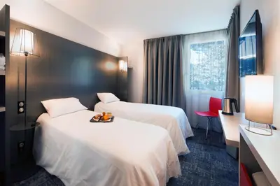 Un ou plusieurs lits dans un hébergement de l'établissement L'hôtel by JOA de Saint-Paul-Lès-Dax